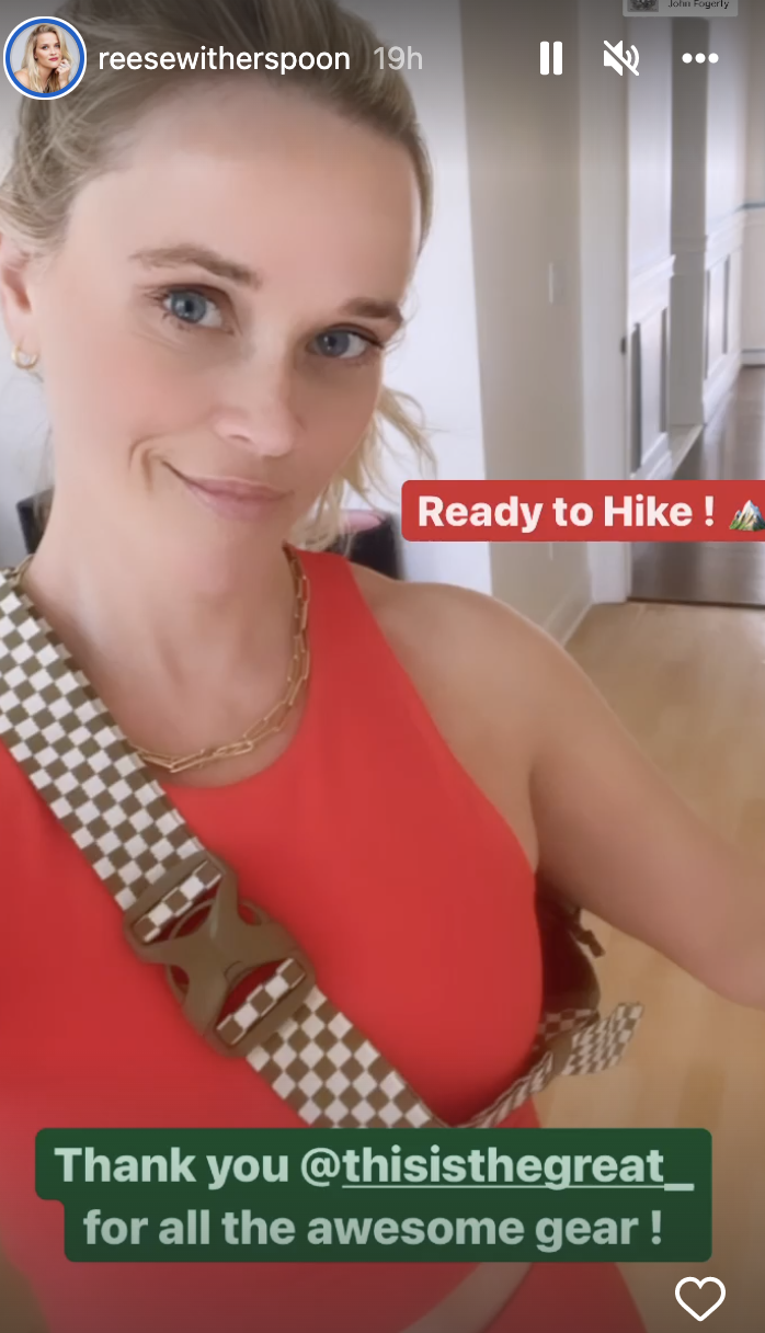 Reese Witherspoon in red sleeveless tank top and plaid bag from The Great + Eddie Bauer limited edition capsule collection