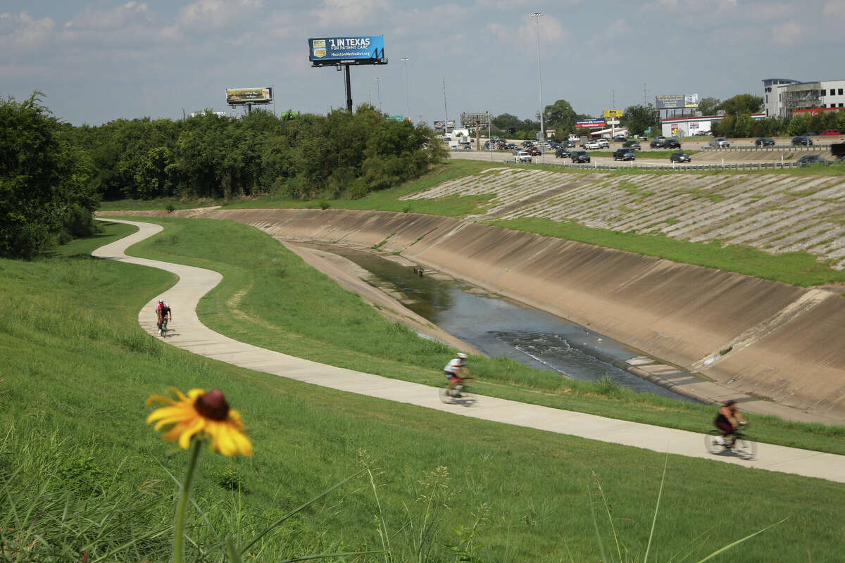Cyclists ride along the White Oak Bayou Trail on August 25, 2018 in Houston, Texas.