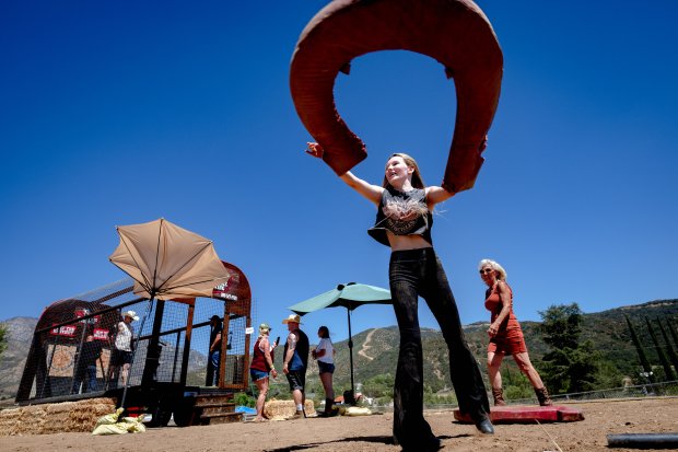 Abbey Carter, 14, plays a game of horseshoes during the Five...