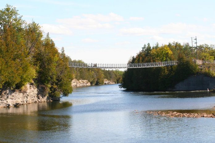The Ranney Gorge Suspension Bridge along the Trent River is recognized as Ontario's most scenic suspension bridge, and paddlers can also enjoy views of the cliffs from below the bridge. (Photo: Jenn McCallum)